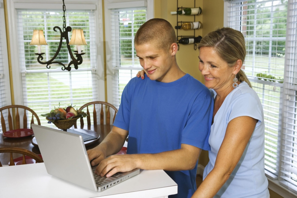 mother and son using laptop